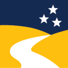 The logo for the college of letters and science. A road through golden hills with three stars in the sky.